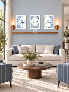 FREMAT Blue Garden shelf set with three 30 x 40 cm frames, 2 cm white borders, honey wood shelf and two warm sensor lamps. Morning refined ivory salon, pale blue-grey wall, blue striped armchairs, round walnut table, cream wool carpet, large garden window left.