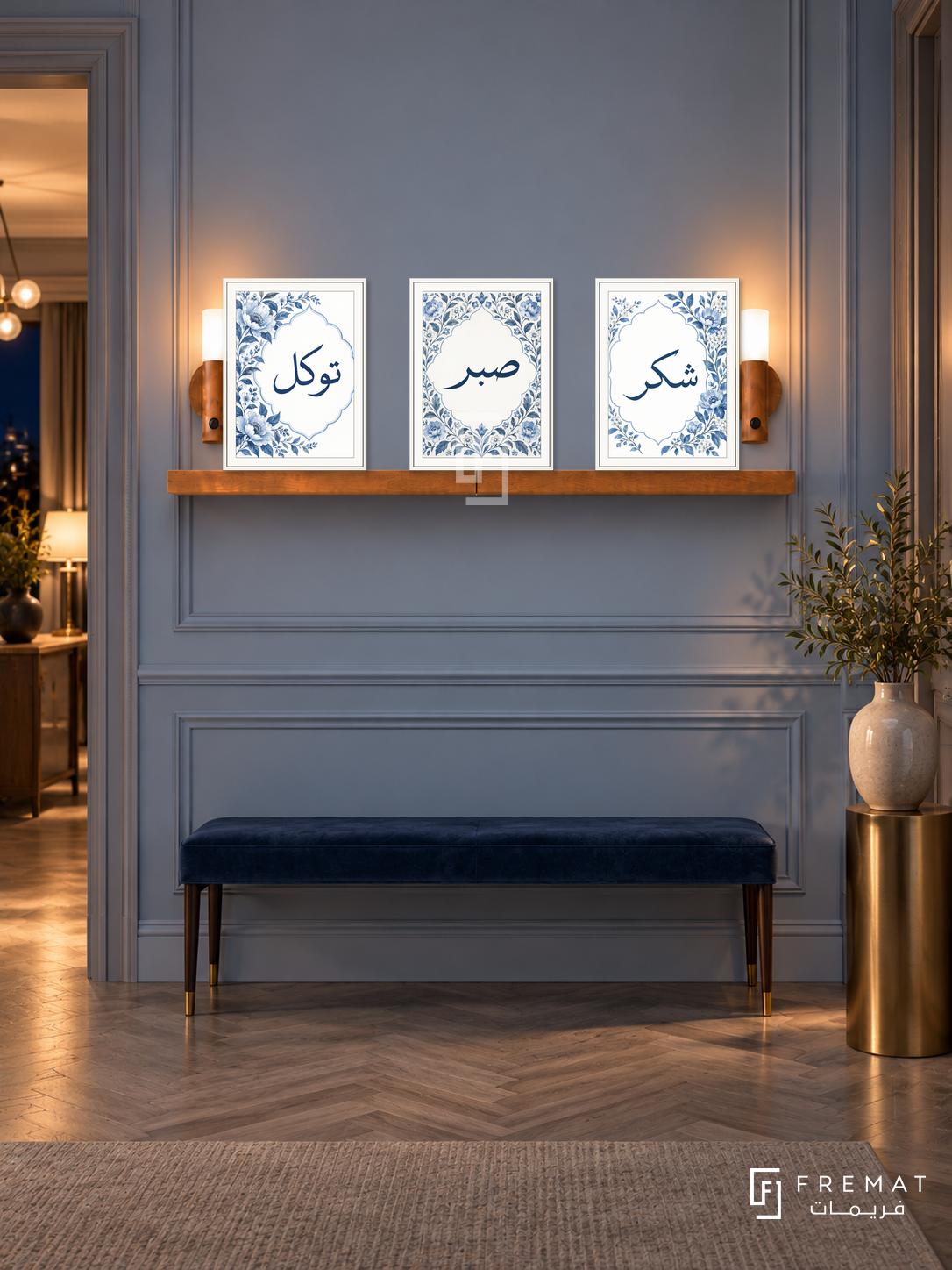 FREMAT Blue Garden shelf set with three 30 x 40 cm frames, 2 cm white borders, honey wood shelf and two warm sensor lamps. Night French contemporary hallway, powder blue panelled wall, narrow navy velvet bench, brass pedestal with ceramic vase, grey parquet, softly glowing doorway left.