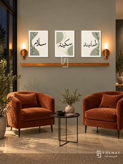 FREMAT Sage Ribbon shelf set with three 30 x 40 cm frames, 2 cm white borders, honey wood shelf and two warm sensor lamps. Night modern conservatory lounge, light grey-green wall, pair of terracotta velvet chairs, small black metal table, limestone floor, dark steel-framed window left.