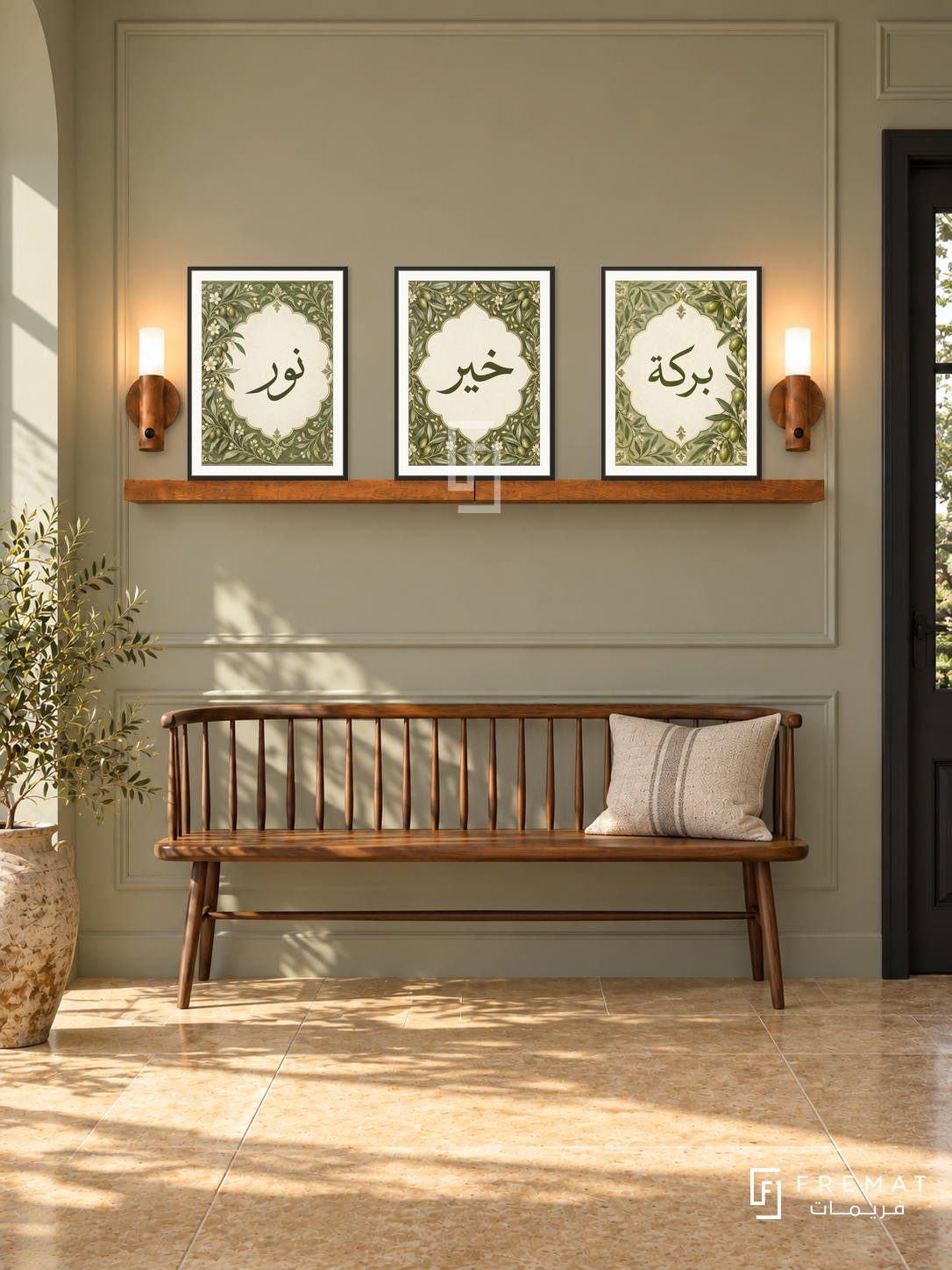 FREMAT Olive Cartouche shelf set with three 30 x 40 cm frames, 2 cm white borders, honey wood shelf and two warm sensor lamps. Morning heritage modern foyer, pale olive wall with simple panel detail, walnut spindle bench, ochre limestone floor, black doorway right, vintage ceramic pot left.