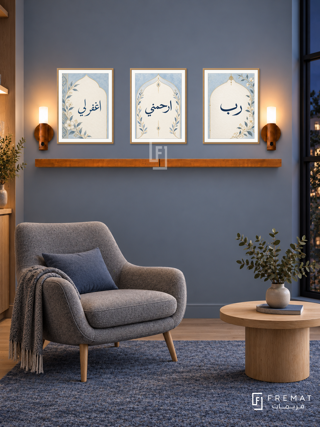 FREMAT Blue Prayer shelf set with three 30 x 40 cm frames, 2 cm white borders, honey wood shelf and two warm sensor lamps. Night Nordic reading room, soft slate-blue wall, grey wool lounge chair with oak legs, pale oak circular table, blue rug, black steel window right.