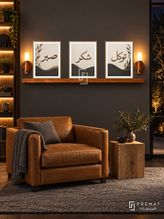 FREMAT Charcoal Linen shelf set with three 30 x 40 cm frames, 2 cm white borders, honey wood shelf and two warm sensor lamps. Night modern dark library, soft charcoal wall, camel leather club chair, oak block side table, grey wool rug, amber-lit bookcase far left.