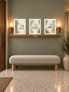 FREMAT Sage Home shelf set with three 30 x 40 cm frames, 2 cm white borders, honey wood shelf and two warm sensor lamps. Night contemporary sage entrance, green-grey wall, oatmeal boucle bench with light wood legs, light terrazzo floor, walnut door left, ceramic floor vessel right.