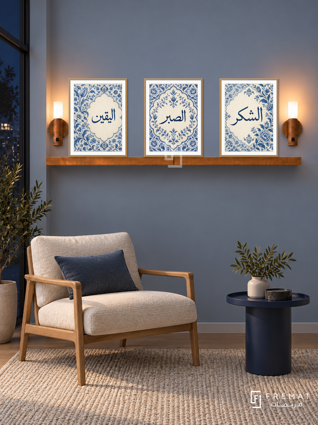 FREMAT Porcelain Devotion shelf set with three 30 x 40 cm wooden texture frames, 2 cm white borders, honey wood shelf and two warm sensor lamps. Night Scandinavian blue reading corner, mist blue wall, ivory lounge chair with oak frame, navy round table, pale woven rug, dark window left.
