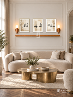 FREMAT Sand Remembrance shelf set with three 30 x 40 cm gold frames, 2 cm white borders, honey wood shelf and two warm sensor lamps. Morning elegant Egyptian reception room, ivory panelled wall, sand velvet curved sofa, sculptural brass coffee table, herringbone walnut flooring, tall curtains left.