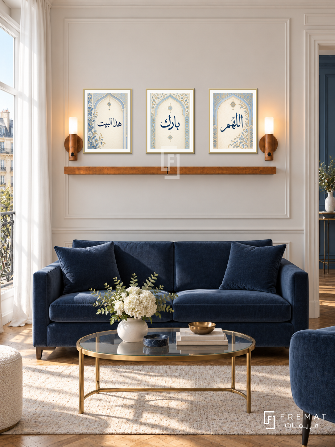 FREMAT Blue Blessing shelf set with three 30 x 40 cm gold frames, 2 cm white borders, honey wood shelf and two warm sensor lamps. Morning Parisian blue reception, ivory wall with fine trim, navy velvet loveseat, brass glass table, walnut parquet, tall white curtains left.
