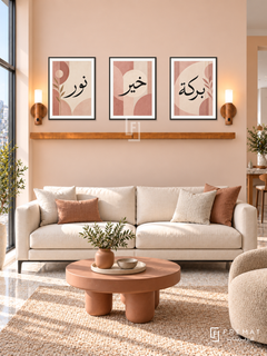 FREMAT Blush Geometry shelf set with three 30 x 40 cm black frames, 2 cm white borders, honey wood shelf and two warm sensor lamps. Morning geometric contemporary lounge, pale peach wall, black-legged ivory sofa, terracotta sculptural coffee table, pale terrazzo floor, window left.