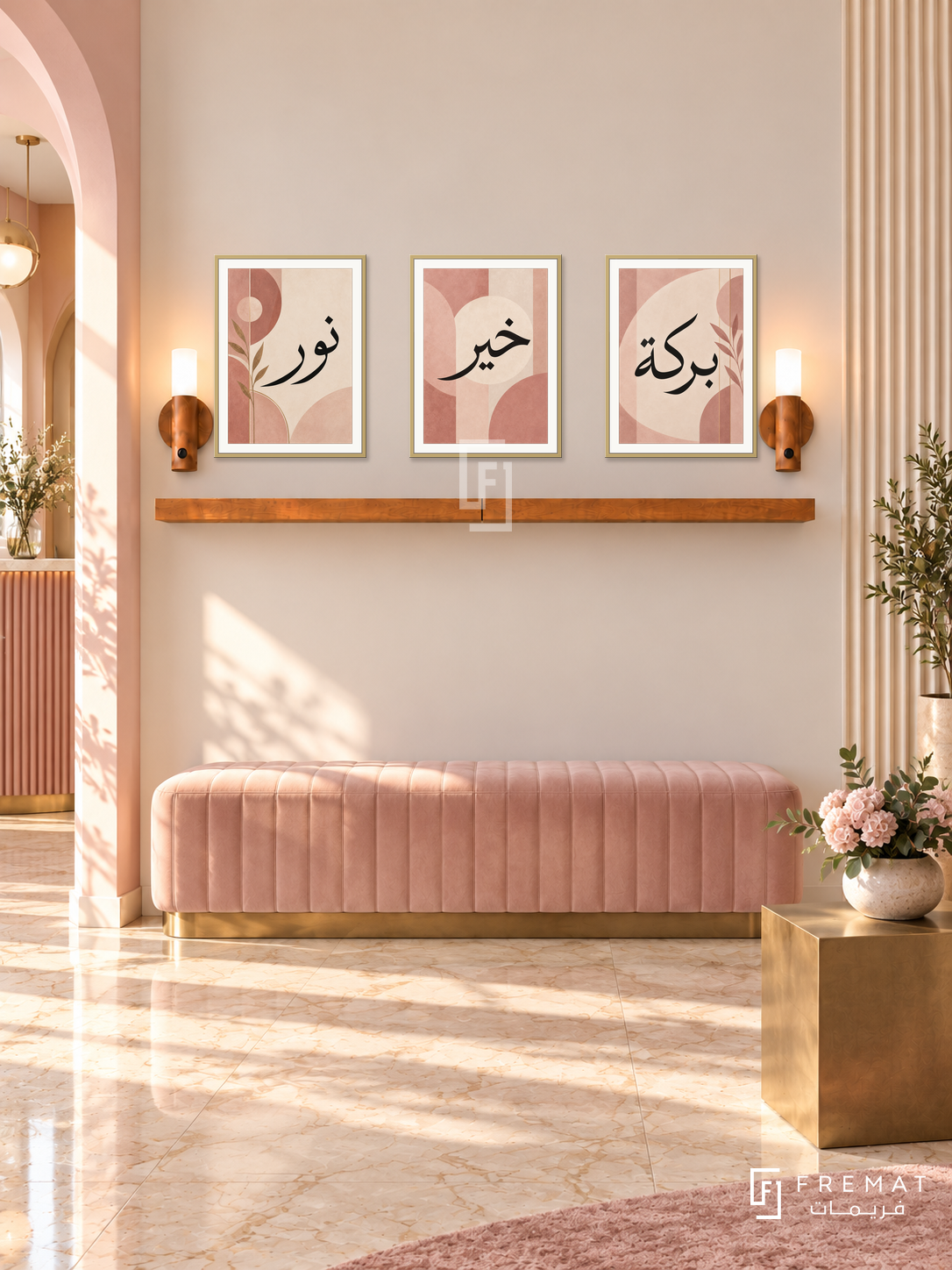 FREMAT Blush Geometry shelf set with three 30 x 40 cm gold frames, 2 cm white borders, honey wood shelf and two warm sensor lamps. Morning Art Deco pink reception, warm ivory fluted sidewall, blush bench beneath plain ivory main wall, brass cube table, cream marble floor, arch doorway left.