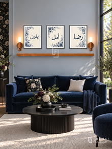 FREMAT Midnight Bloom shelf set with three 30 x 40 cm black frames, 2 cm white borders, honey wood shelf and two warm sensor lamps. Morning sophisticated dark floral reception, pale blue-grey wall, midnight blue velvet sofa, black round table, ivory rug, bright garden window right.
