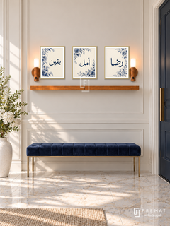 FREMAT Midnight Bloom shelf set with three 30 x 40 cm gold frames, 2 cm white borders, honey wood shelf and two warm sensor lamps. Morning elegant entrance, light cream panelled wall, navy velvet bench, brass legs, pale marble tiles, tall door right and white floral vase left.
