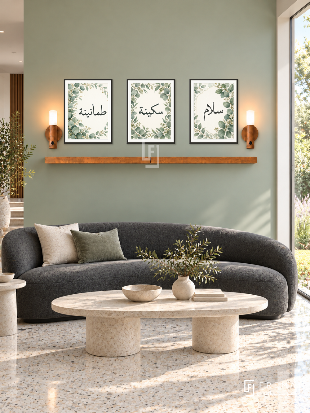 FREMAT Eucalyptus Calm shelf set with three 30 x 40 cm black frames, 2 cm white borders, honey wood shelf and two warm sensor lamps. Morning contemporary garden reception, pale eucalyptus green wall, charcoal curved sofa, oval limestone coffee table, cream terrazzo floor, broad bright garden window right.