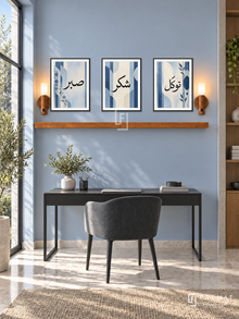 FREMAT Soft Cobalt shelf set with three 30 x 40 cm black frames, 2 cm white borders, honey wood shelf and two warm sensor lamps. Morning architectural blue study, mist blue wall, compact charcoal chair and black desk below shelf, pale stone floor, tall garden window left, modern restrained furnishings.
