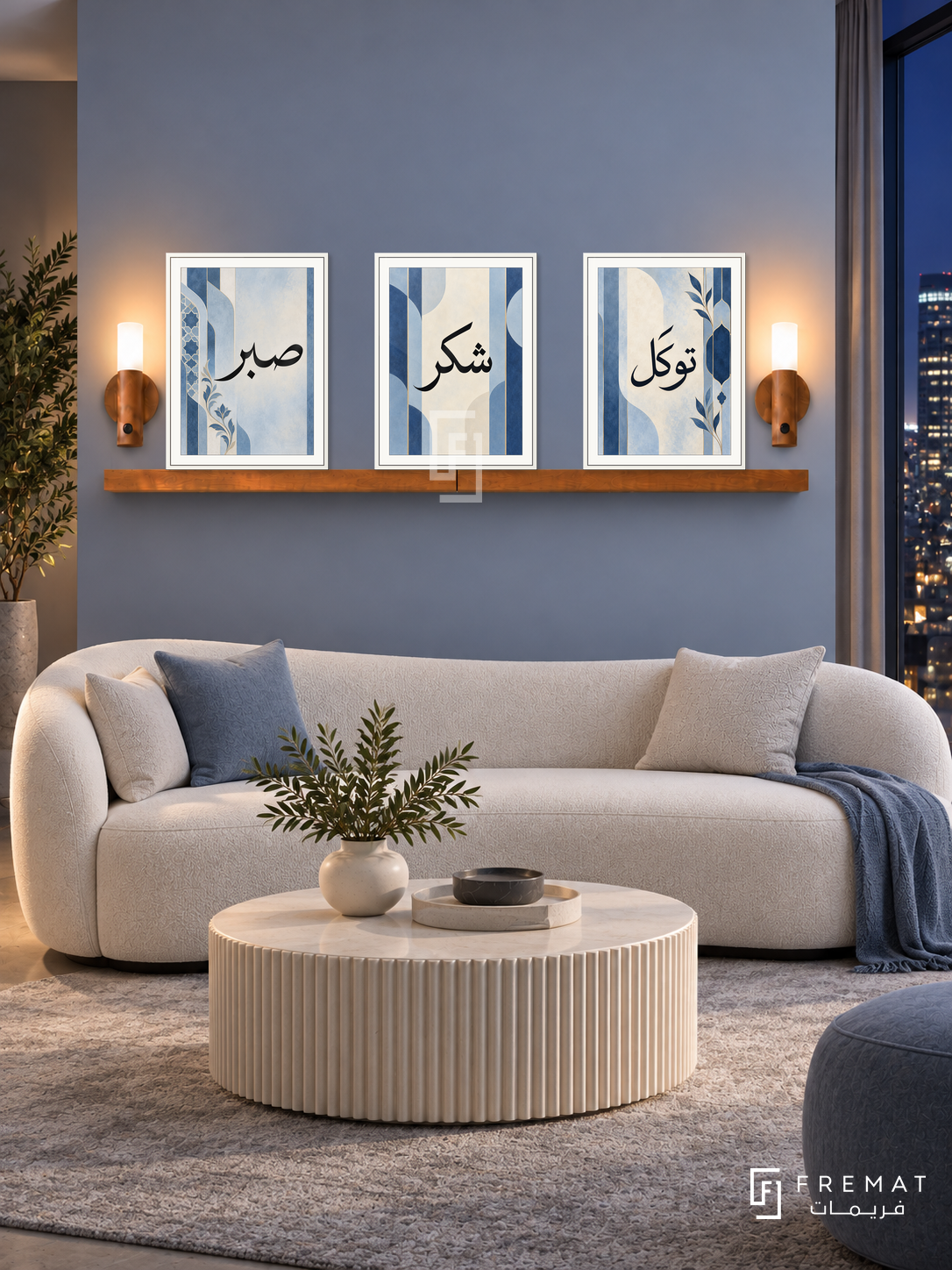 FREMAT Soft Cobalt shelf set with three 30 x 40 cm white frames, 2 cm white borders, honey wood shelf and two warm sensor lamps. Night contemporary powder-blue reception, blue-grey wall, white curved sofa, ivory fluted round coffee table, soft grey carpet, dark city window right.