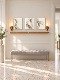 FREMAT Linen Wind shelf set with three 30 x 40 cm gold frames, 2 cm white borders, honey wood shelf and two warm sensor lamps. Morning soft neoclassical hallway, cream wall with wide mouldings, pale grey tufted bench with brass legs, ivory terrazzo floor, bright doorway right, ceramic pedestal far left.