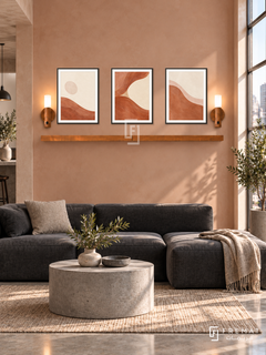 FREMAT Clay Tide shelf set with three 30 x 40 cm black frames, 2 cm white borders, honey wood shelf and two warm sensor lamps. Morning urban loft living room, pale terracotta plaster wall, low charcoal modular sofa, cylindrical grey concrete table, polished concrete floor, tall bright steel window right.