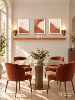 FREMAT Clay Tide shelf set with three 30 x 40 cm gold frames, 2 cm white borders, honey wood shelf and two warm sensor lamps. Morning sophisticated warm dining room, almond cream wall, round bronze-based glass table, rust velvet chairs, pale herringbone floor, garden French window left.