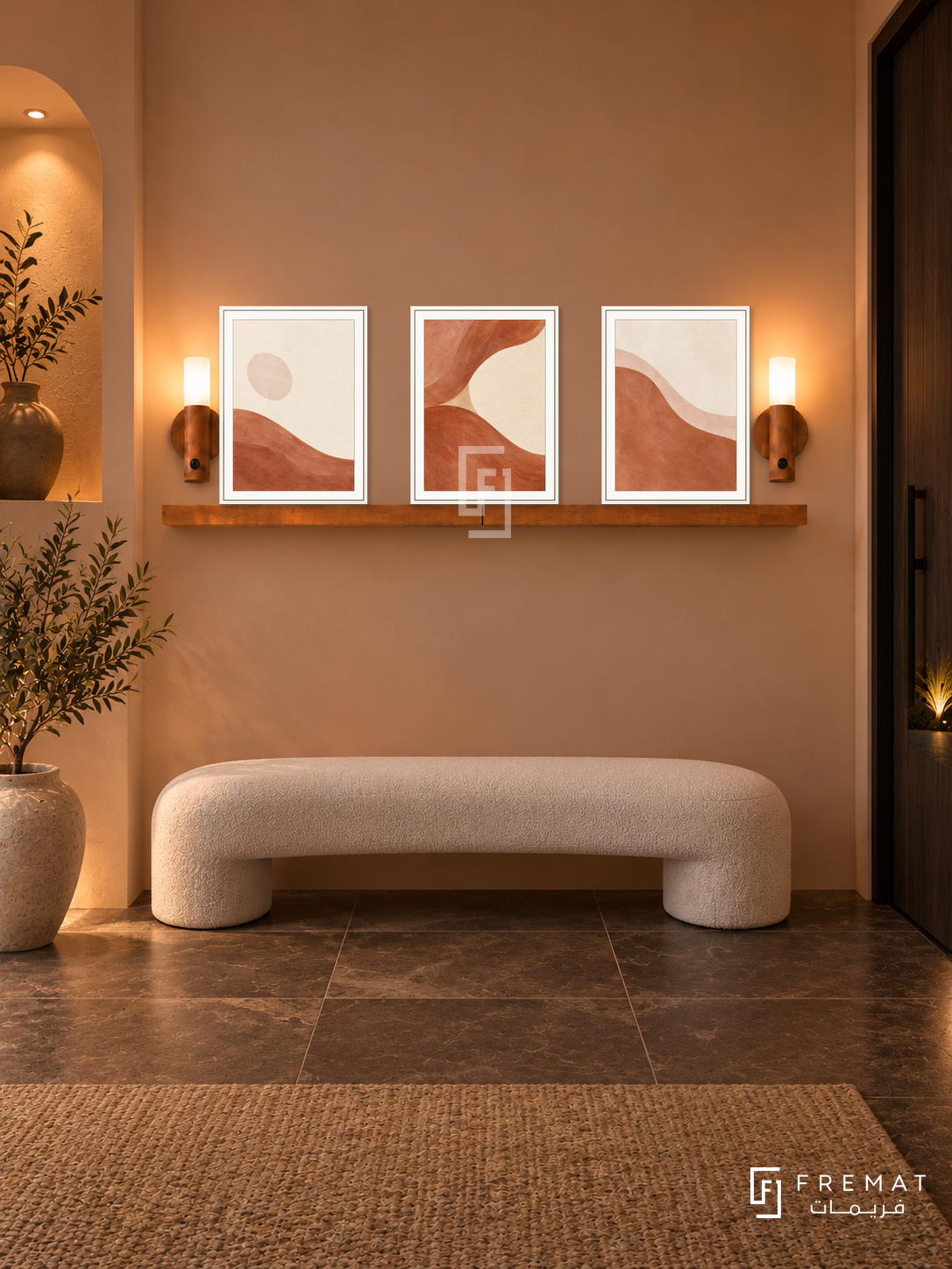 FREMAT Clay Tide shelf set with three 30 x 40 cm white frames, 2 cm white borders, honey wood shelf and two warm sensor lamps. Night contemporary desert foyer, dusty peach wall, white upholstered curved bench, dark brown limestone tiles, dark entrance door right, soft recessed arch left.