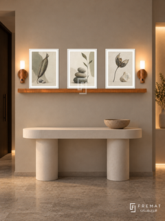 FREMAT Seed And Stone shelf set with three 30 x 40 cm white frames, 2 cm white borders, honey wood shelf and two warm sensor lamps. Night warm minimalist corridor, greige plaster wall, white sculptural console with a single clay bowl, grey limestone floor, dark doorway left, warm recessed niche right.