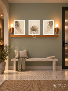 FREMAT Palm Shadow Study shelf set with three 30 x 40 cm white frames, 2 cm white borders, honey wood shelf and two warm sensor lamps. Night contemporary coastal hallway, muted sage wall, whitewashed timber bench, pale terrazzo floor, dark reed-glass door right, warm ceiling lighting.