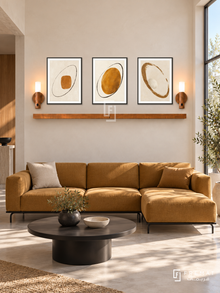FREMAT Ochre Orbit shelf set with three 30 x 40 cm black frames, 2 cm white borders, honey wood shelf and two warm sensor lamps. Morning Bauhaus-inspired reception, warm ivory plaster wall, ochre modular sofa with black tubular legs, black round coffee table, pale concrete floor, large sunny square window right.