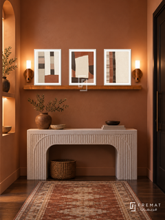 FREMAT Desert Textiles shelf set with three 30 x 40 cm white frames, 2 cm white borders, honey wood shelf and two warm sensor lamps. Night contemporary terracotta corridor, dusty clay wall, white carved console, rust and cream runner, dark wood floor, dark entry door right, lit niche left.