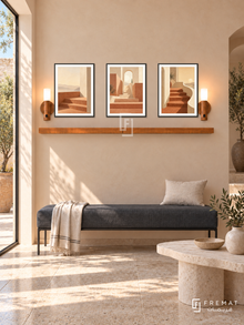 FREMAT Terrace Of Light shelf set with three 30 x 40 cm black frames, 2 cm white borders, honey wood shelf and two warm sensor lamps. Morning modern Mediterranean reception, pale apricot plaster wall, charcoal linen bench with slim steel base, asymmetric limestone table, travertine floor, tall sunlit doorway on left.
