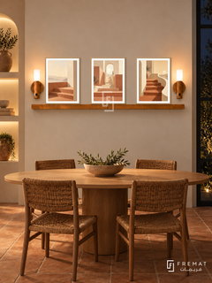 FREMAT Terrace Of Light shelf set with three 30 x 40 cm wooden texture frames, 2 cm white borders, honey wood shelf and two warm sensor lamps. Night modern coastal dining nook, cream limewash wall, oval oak table and woven caramel chairs, terracotta tiled floor, dark narrow window on right, softly illuminated recessed display alcove left.