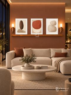 FREMAT Earthen Balance shelf set with three 30 x 40 cm white frames, 2 cm white borders, honey wood shelf and two warm sensor lamps. Night contemporary living room with muted terracotta wall, cream modular sofa, oval white stone table, oatmeal rug, dark glass doors left, soft ceiling coves.