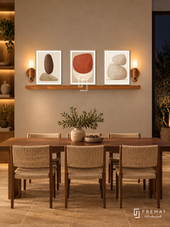 FREMAT Earthen Balance shelf set with three 30 x 40 cm wooden texture frames, 2 cm white borders, honey wood shelf and two warm sensor lamps. Night rustic-modern dining space, warm chalk wall, rectangular walnut table with woven cream chairs, sandstone floor, dark window right, softly lit timber shelving left.
