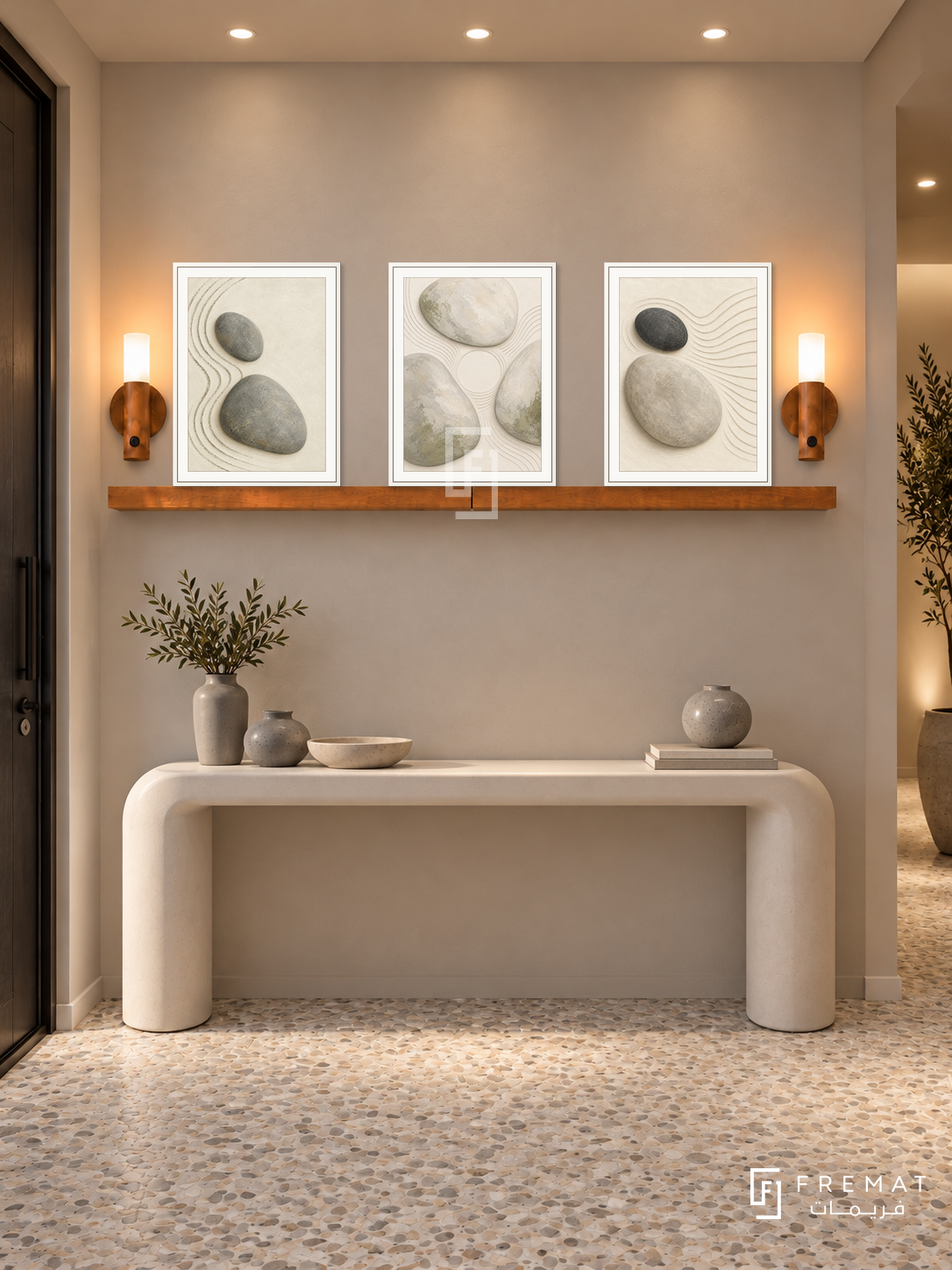 FREMAT Pebble Garden shelf set with three 30 x 40 cm white frames, 2 cm white borders, honey wood shelf and two warm sensor lamps. Night minimalist entry, light mushroom wall, white rounded console with grey ceramic vessels, pale pebble mosaic floor, dark door left, warm ceiling spots.