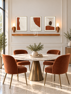 FREMAT Rust And Chalk shelf set with three 30 x 40 cm gold frames, 2 cm white borders, honey wood shelf and two warm sensor lamps. Morning contemporary deco dining room, ivory panelled wall, round bronze based marble dining table and rust velvet chairs, cream tiled floor, sunny tall window left.