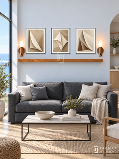 FREMAT Paper Sails shelf set with three 30 x 40 cm black frames, 2 cm white borders, honey wood shelf and two warm sensor lamps. Morning Nordic coastal living room, pale blue white wall, charcoal linen sofa, thin black coffee table with pale stone top, light oak floor, large sunny sea window left.