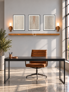 FREMAT Copper Rain shelf set with three 30 x 40 cm black frames, 2 cm white borders, honey wood shelf and two warm sensor lamps. Morning industrial contemporary study, pale grey wall, black metal desk with cognac chair, polished concrete, sunny factory window right, copper desk accessory low left.