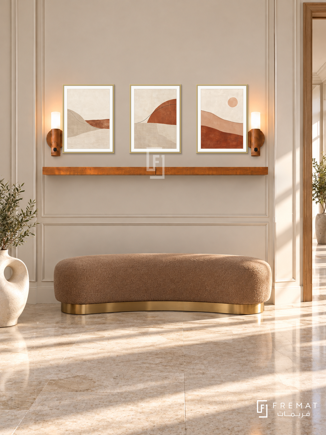 FREMAT Horizon Stitch shelf set with three 30 x 40 cm gold frames, 2 cm white borders, honey wood shelf and two warm sensor lamps. Morning refined hotel corridor, pale oatmeal panelled wall, curved tan bench with brass base, cream and beige stone floor, sunlit door opening right, sculptural ceramic low left.