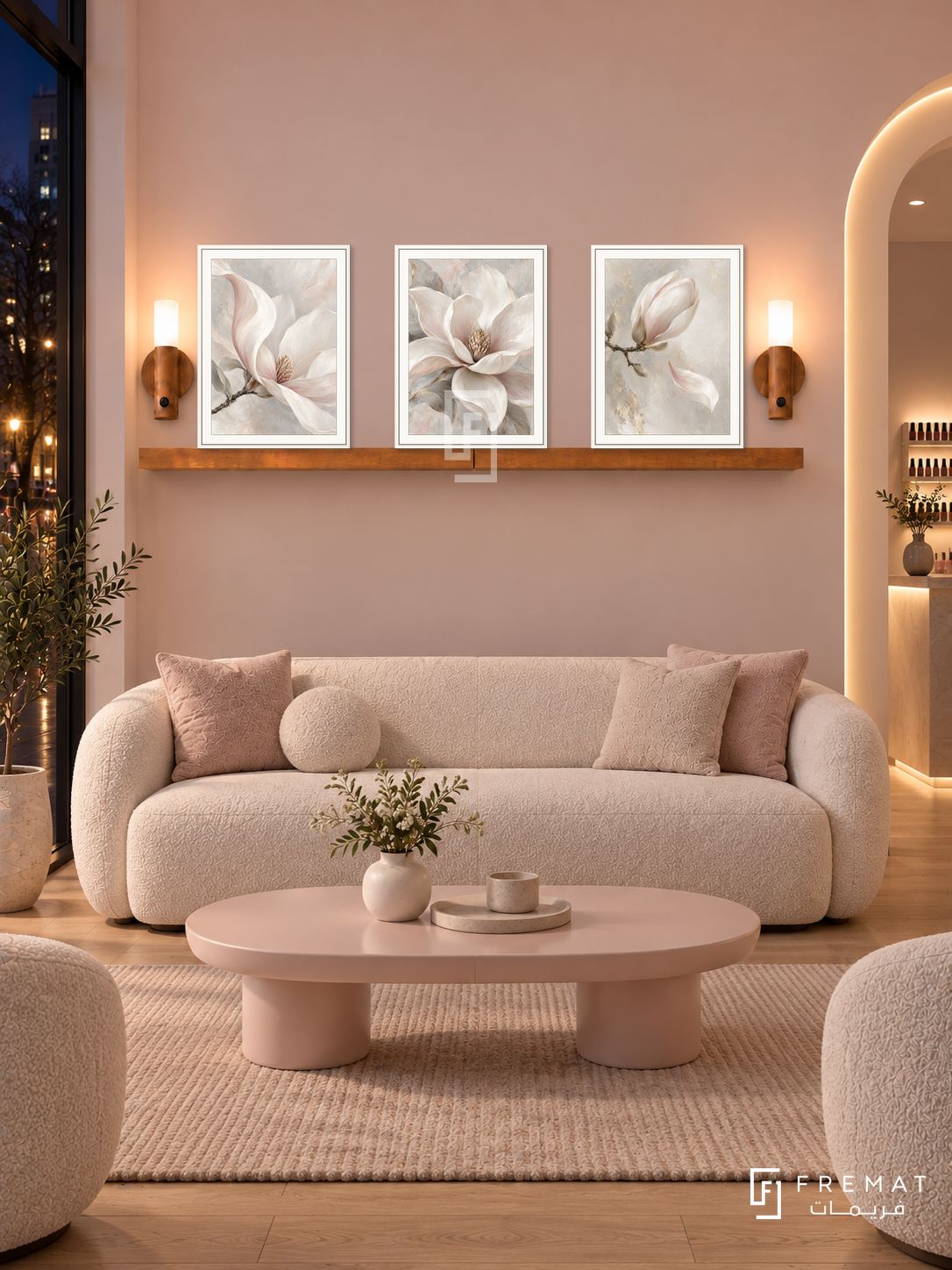 FREMAT Pearl Bloom shelf set with three 30 x 40 cm white frames, 2 cm white borders, honey wood shelf and two warm sensor lamps. Night contemporary nail salon lounge, pearl blush wall, white boucle sofa, pale pink oval table, light oak flooring, dark street window left, curved lit doorway far right.