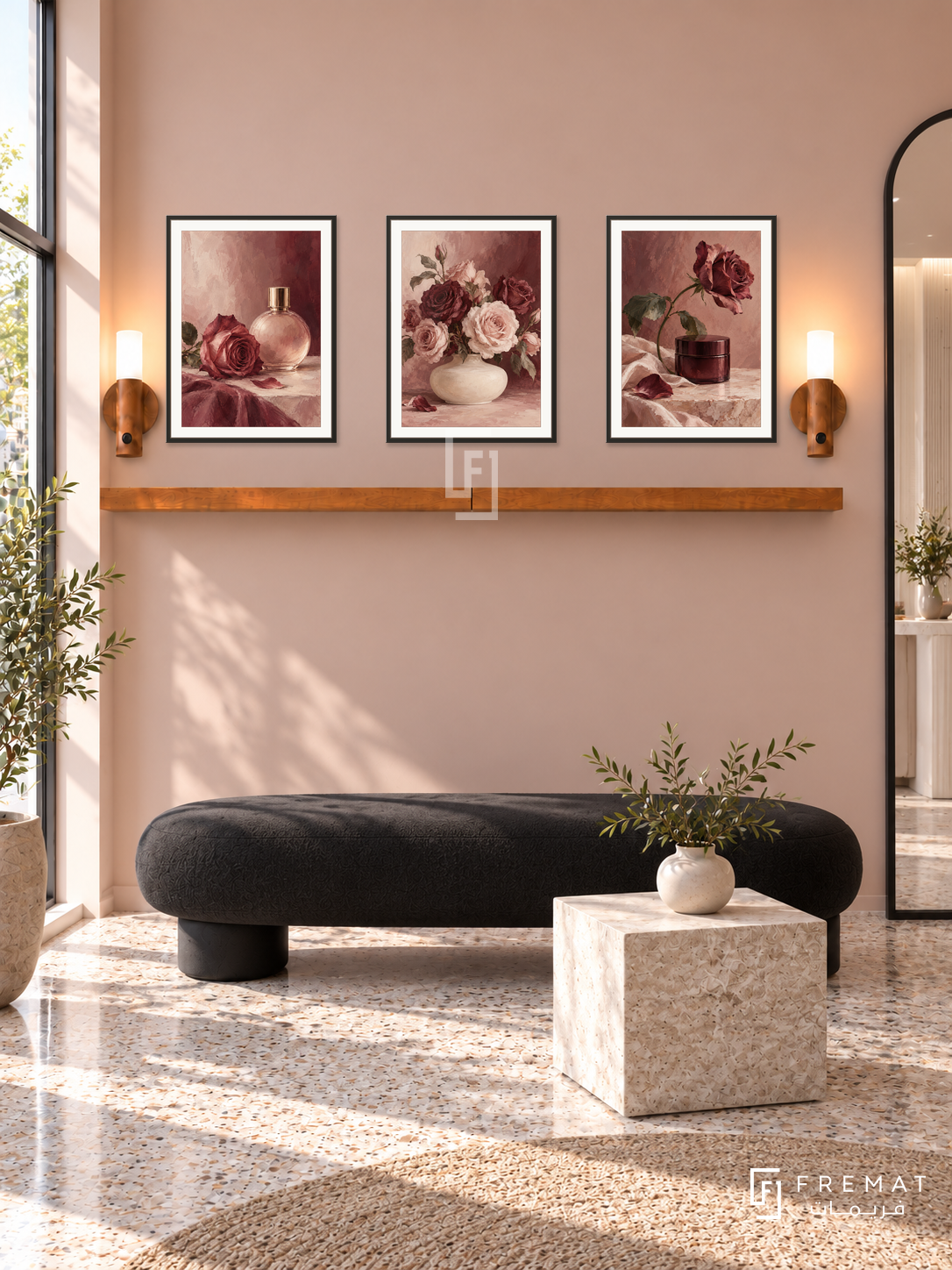 FREMAT Rose Atelier shelf set with three 30 x 40 cm black frames, 2 cm white borders, honey wood shelf and two warm sensor lamps. Morning minimalist makeup studio reception, soft rose wall, black rounded bench and pale stone cube table, terrazzo floor, bright storefront left, tall black mirror at far right.
