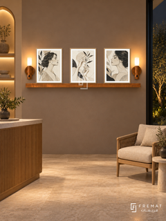 FREMAT Contour Muse shelf set with three 30 x 40 cm wooden texture frames, 2 cm white borders, honey wood shelf and two warm sensor lamps. Night earthy wellness reception, clay taupe wall, oak reception counter low left, woven linen armchair right, pale stone floor, dark garden window right and warm wall niches.
