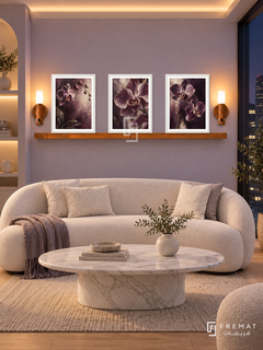 FREMAT Velvet Orchid shelf set with three 30 x 40 cm white frames, 2 cm white borders, honey wood shelf and two warm sensor lamps. Night serene beauty lounge, muted lavender wall, white curved sofa and white marble oval table, pale oak floor, dark city window right, soft warm ceiling wash.
