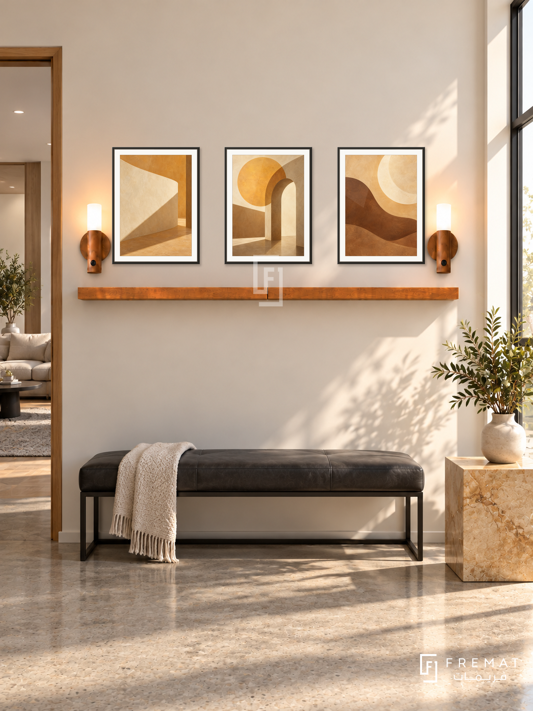FREMAT Golden Hour shelf set with three 30 x 40 cm black frames, 2 cm white borders, honey wood shelf and two warm sensor lamps. Morning modern salon entrance lounge, warm ivory wall, charcoal leather bench and golden stone cube table, polished concrete floor, strong sunlight through high window right, styling room doorway left.