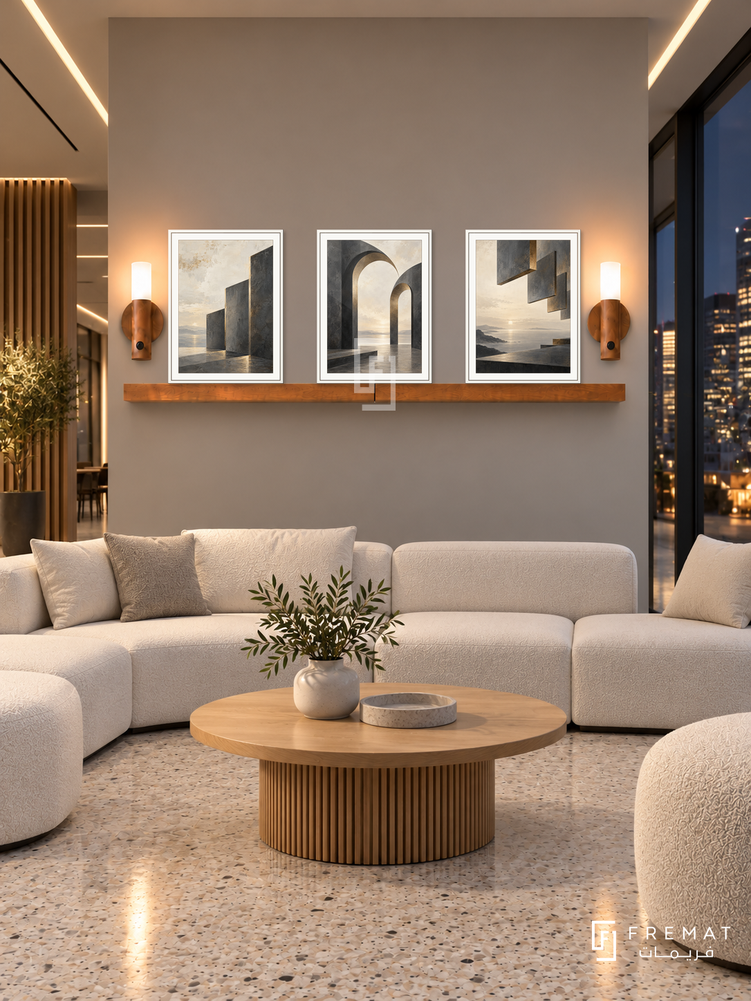 FREMAT Shared Horizon shelf set with three 30 x 40 cm white frames, 2 cm white borders, honey wood shelf and two warm sensor lamps. Night modern coworking lobby, warm grey wall, white modular seating and oak round table, pale terrazzo floor, dark city windows right, luminous ceiling slots.
