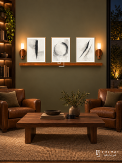 FREMAT Quiet Focus shelf set with three 30 x 40 cm wooden texture frames, 2 cm white borders, honey wood shelf and two warm sensor lamps. Night warm corporate library lounge, muted olive display wall, tobacco leather club chairs, rectangular walnut table, tan rug, low lit bookshelves left, dark courtyard window right.