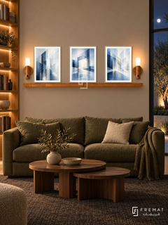 FREMAT Blueprints Of Light shelf set with three 30 x 40 cm wooden texture frames, 2 cm white borders, honey wood shelf and two warm sensor lamps. Night editorial studio library, warm putty display wall, olive linen sofa, walnut nesting tables, dark wool rug, illuminated oak library left, moonlit courtyard glazing right.