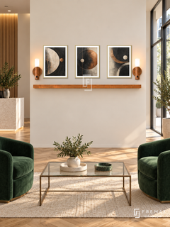 FREMAT Copper Orbit shelf set with three 30 x 40 cm gold frames, 2 cm white borders, honey wood shelf and two warm sensor lamps. Morning elegant agency reception, ivory display wall, forest green velvet chairs, glass rectangular coffee table with bronze legs, honey parquet floor, bright glazed door right.