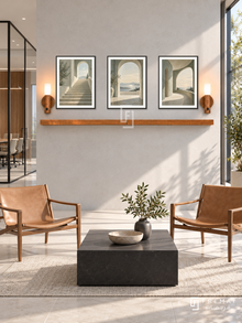 FREMAT Open Perspective shelf set with three 30 x 40 cm black frames, 2 cm white borders, honey wood shelf and two warm sensor lamps. Morning minimalist architecture firm reception, light concrete display wall, two tan leather sling chairs, low square black table, pale tiled floor, large sunny glazing right, glass meeting room left.
