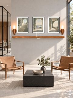 FREMAT Open Perspective shelf set with three 30 x 40 cm black frames, 2 cm white borders, honey wood shelf and two warm sensor lamps. Morning minimalist architecture firm reception, light concrete display wall, two tan leather sling chairs, low square black table, pale tiled floor, large sunny glazing right, glass meeting room left.