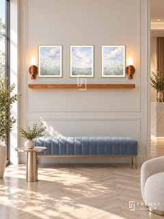 FREMAT Cloud Garden shelf set with three 30 x 40 cm gold frames, 2 cm white borders, honey wood shelf and two warm sensor lamps. Morning private clinic lounge, warm ivory paneled wall, powder blue velvet bench, champagne metal small table, pale herringbone floor, bright glazing left.