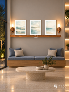 FREMAT Soft Horizon shelf set with three 30 x 40 cm wooden texture frames, 2 cm white borders, honey wood shelf and two warm sensor lamps. Night rehabilitation waiting nook, warm grey display wall, oak bench with dusty blue cushions, low oval limestone table, cream tile floor, dark courtyard left, illuminated shelving right.