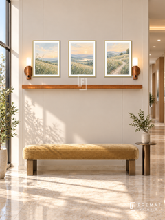 FREMAT New Light shelf set with three 30 x 40 cm gold frames, 2 cm white borders, honey wood shelf and two warm sensor lamps. Morning private health clinic entry, warm ivory paneled display wall, muted gold upholstered bench, narrow bronze table, cream stone floor, tall sunny window left, open corridor right.