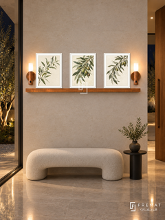 FREMAT Olive Orchard shelf set with three 30 x 40 cm white frames, 2 cm white borders, honey wood shelf and two warm sensor lamps. Night minimalist entrance hallway, pale limestone wall, sculptural cream bench, round black side table, polished stone floor, glazed courtyard left and walnut pivot door right.