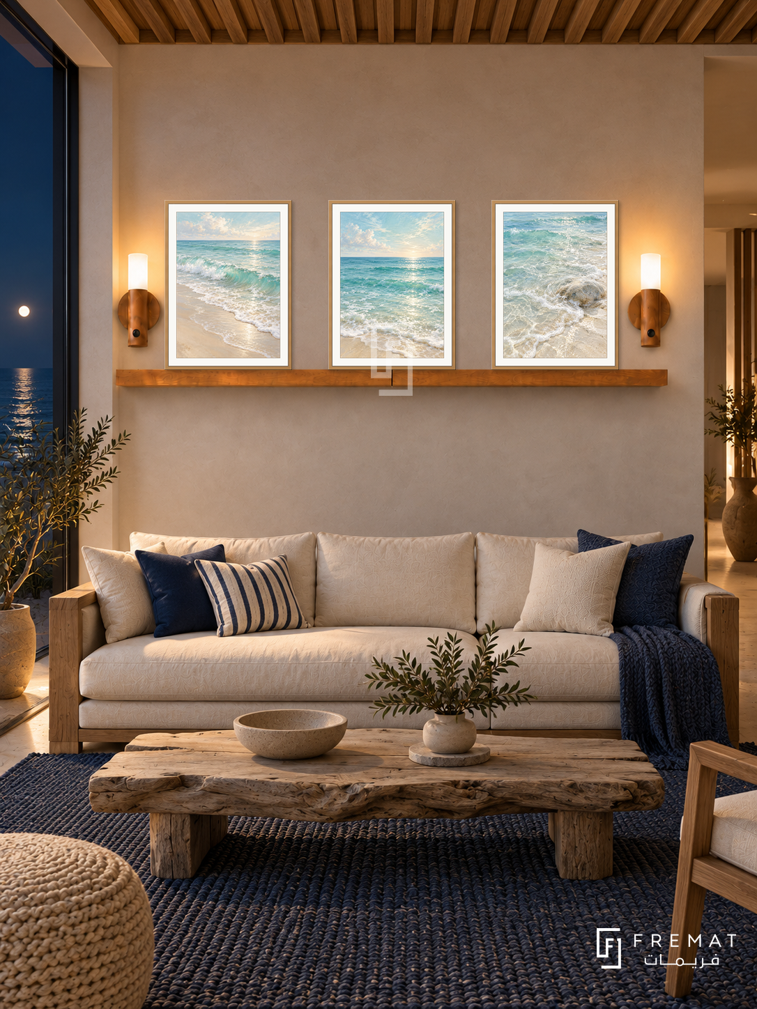 FREMAT Ocean Breath shelf set with three 30 x 40 cm wooden texture frames, 2 cm white borders, honey wood shelf and two warm sensor lamps. Night modern beach house lounge, sandy plaster, cream sofa with teak arms, long driftwood table, woven navy rug, ocean glazing left, timber ceiling battens.